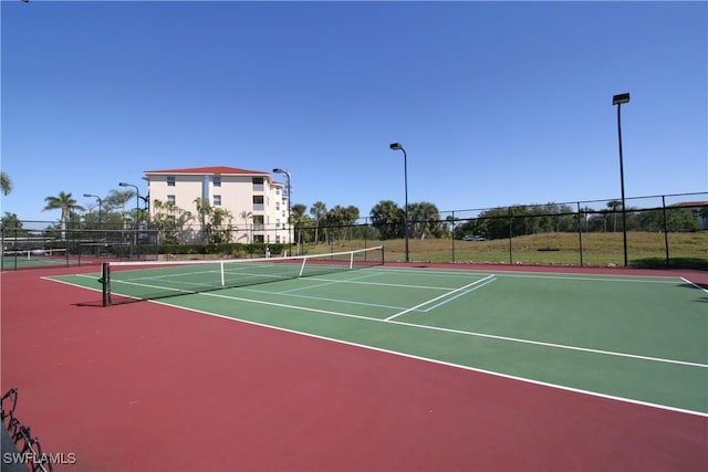 view of tennis court featuring basketball court