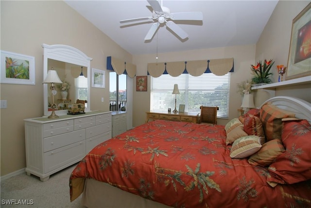 bedroom with ceiling fan, light colored carpet, and lofted ceiling