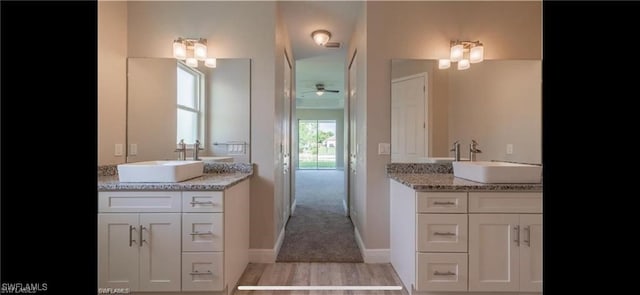 bathroom with vanity, hardwood / wood-style flooring, and ceiling fan