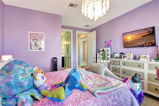 carpeted bedroom with visible vents, a notable chandelier, and ensuite bathroom