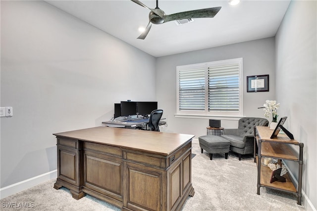 office featuring ceiling fan, visible vents, baseboards, and light colored carpet