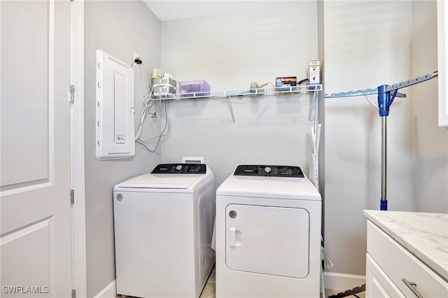 washroom featuring cabinet space, electric panel, and washer and dryer