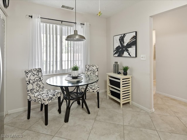 dining area with light tile patterned floors