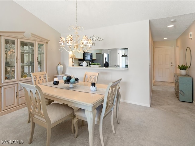 dining space featuring light colored carpet, a textured ceiling, and a chandelier