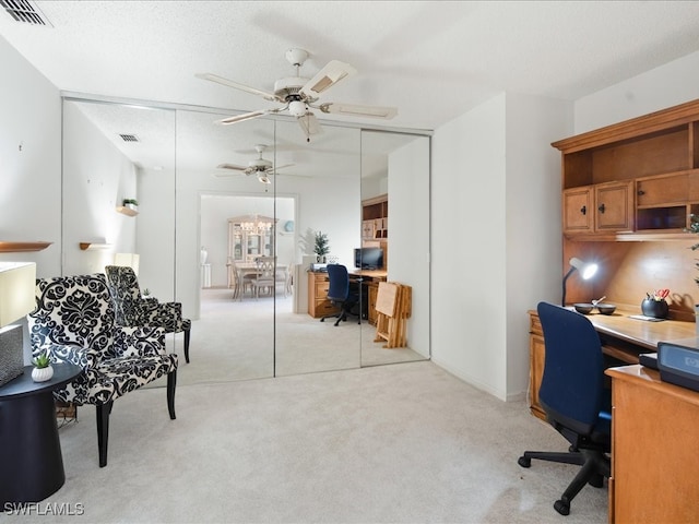 office area with ceiling fan, light carpet, and a textured ceiling