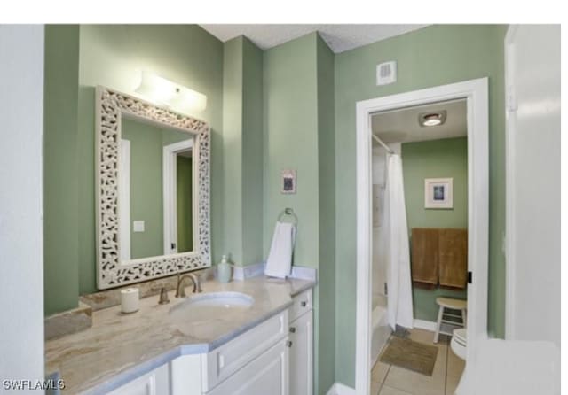 bathroom featuring shower / bath combination with curtain, vanity, and tile patterned floors