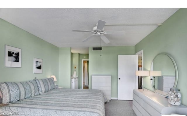 bedroom with carpet flooring, ceiling fan, and a textured ceiling