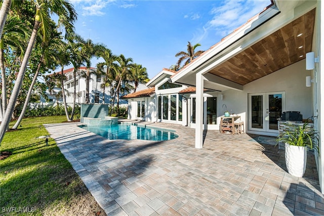 view of pool with french doors, ceiling fan, and a patio area