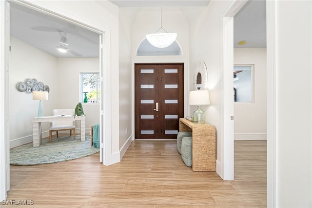 foyer featuring light hardwood / wood-style flooring and ceiling fan