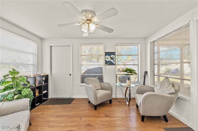 sitting room featuring ceiling fan and light hardwood / wood-style floors