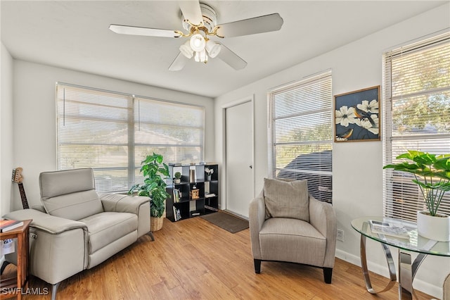 sitting room featuring light hardwood / wood-style flooring, plenty of natural light, and ceiling fan