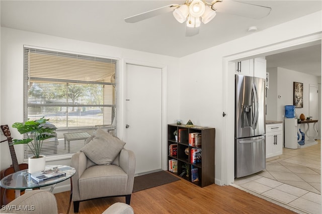 sitting room with ceiling fan and light hardwood / wood-style floors