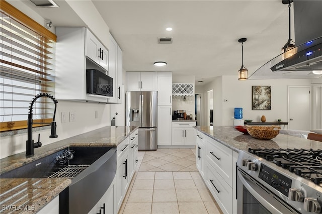 kitchen featuring light stone countertops, stainless steel appliances, and white cabinetry