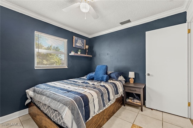 tiled bedroom featuring a textured ceiling, ceiling fan, and crown molding