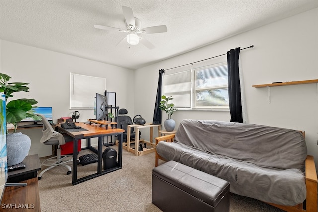 carpeted office space featuring ceiling fan and a textured ceiling