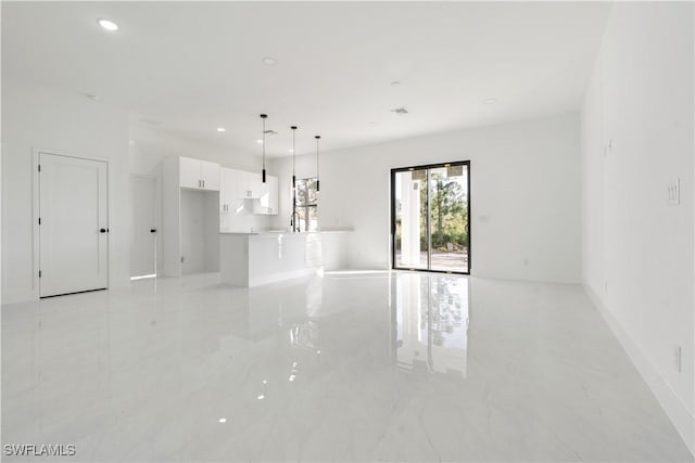 empty room featuring recessed lighting and marble finish floor