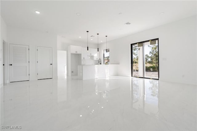 interior space featuring marble finish floor, a sink, visible vents, and recessed lighting