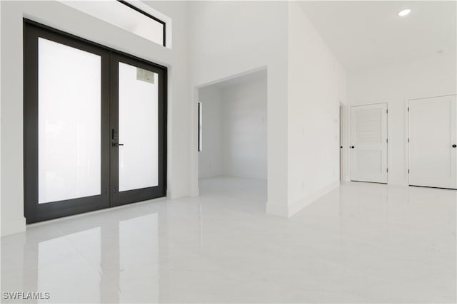 foyer entrance featuring recessed lighting, french doors, and a high ceiling