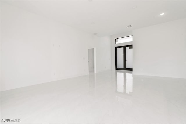 unfurnished room featuring french doors, visible vents, and recessed lighting