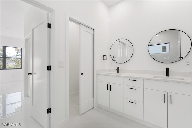 bathroom featuring a sink and double vanity