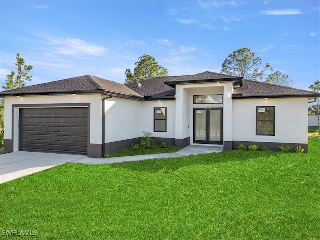 prairie-style home featuring a front lawn and a garage