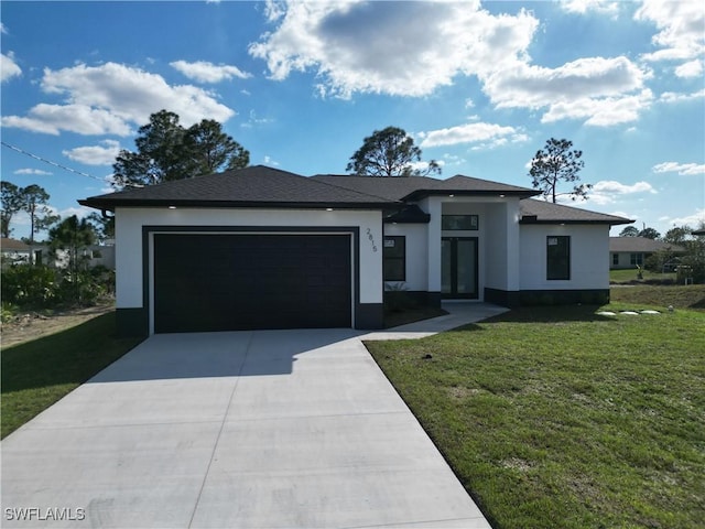 prairie-style home featuring a front yard, concrete driveway, an attached garage, and stucco siding