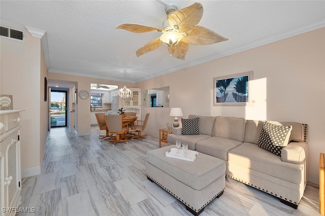 living room featuring crown molding, a textured ceiling, and ceiling fan