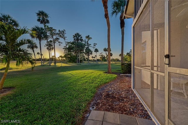 4366 27th Ct SW Unit 1-106, Naples, FL 34116 - yard at dusk with a yard