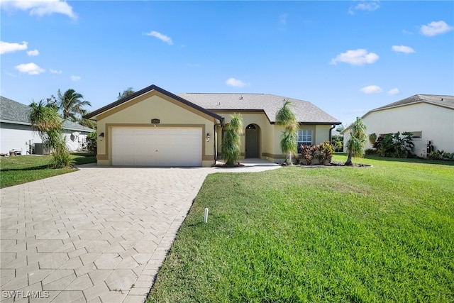 ranch-style house featuring a front yard, a garage, and central AC unit