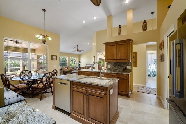 kitchen with ceiling fan with notable chandelier, sink, decorative backsplash, decorative light fixtures, and stainless steel appliances