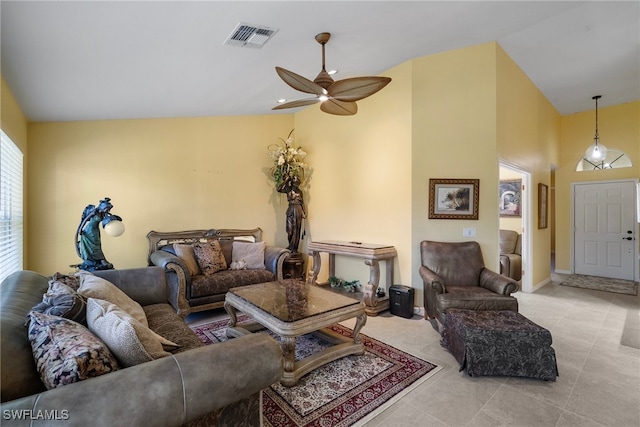 living room with ceiling fan, light tile patterned floors, and vaulted ceiling