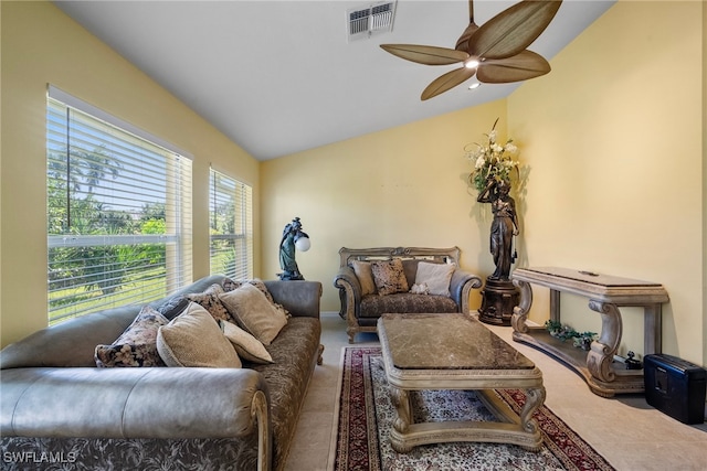 living room featuring ceiling fan, plenty of natural light, and lofted ceiling