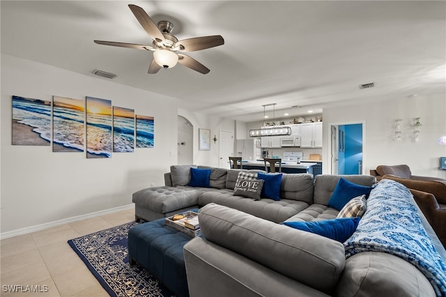 living room featuring ceiling fan and light tile patterned floors