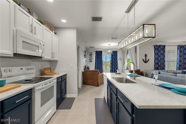 kitchen with white appliances, white cabinetry, hanging light fixtures, and sink