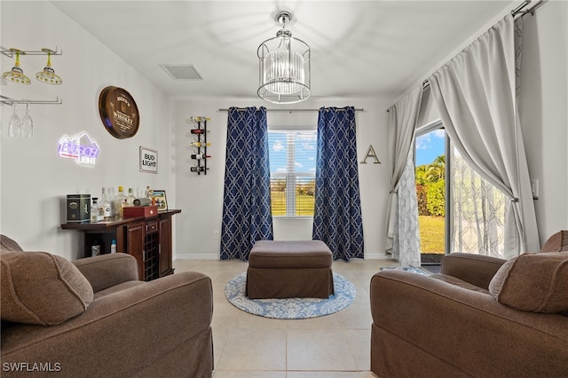 tiled living room with a notable chandelier