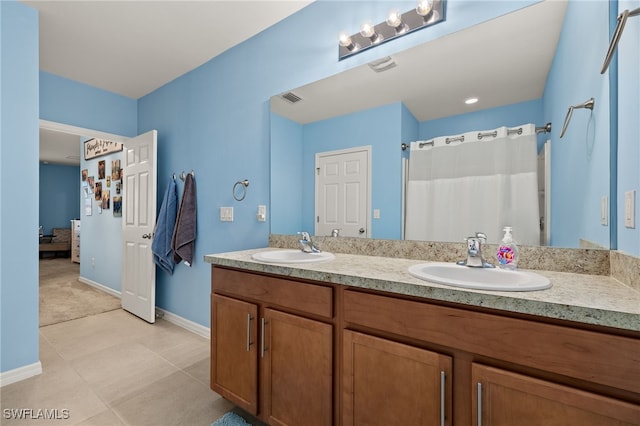 bathroom featuring vanity, tile patterned floors, and curtained shower