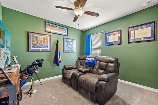 carpeted home theater room featuring ceiling fan