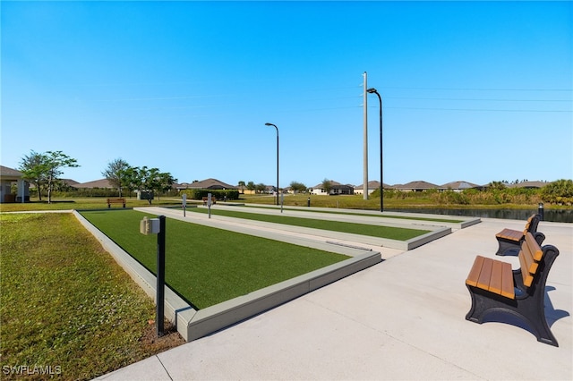 view of home's community with a yard