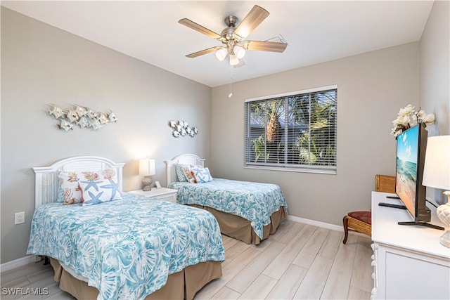 bedroom with light hardwood / wood-style floors and ceiling fan