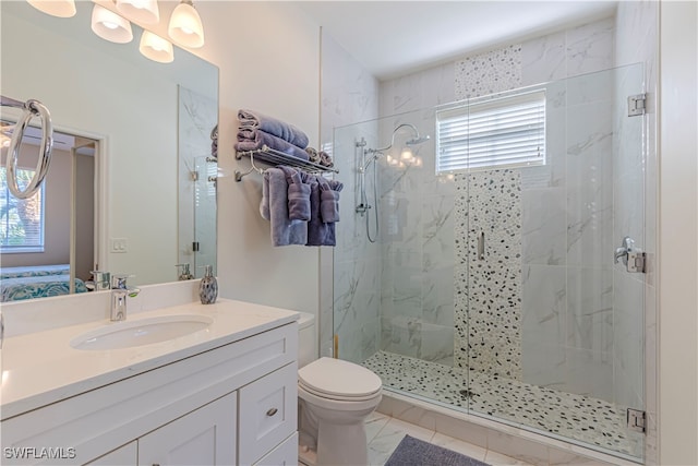 bathroom with tile patterned floors, a shower with door, vanity, and toilet