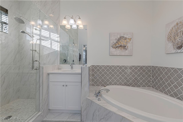 bathroom featuring vanity and shower with separate bathtub