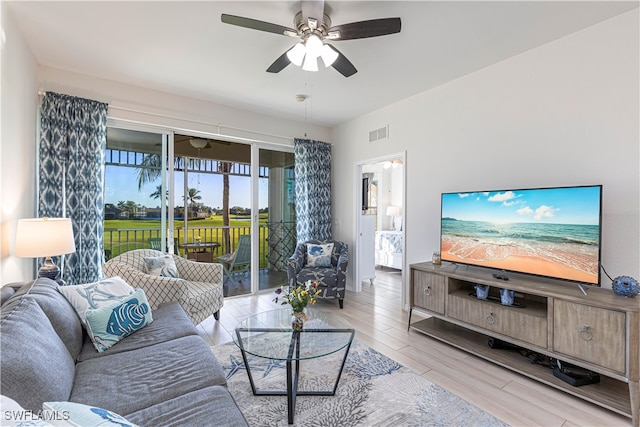 living room featuring light wood-type flooring and ceiling fan