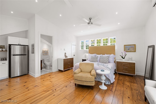 bedroom with ensuite bath, stainless steel fridge, ceiling fan, and light wood-type flooring