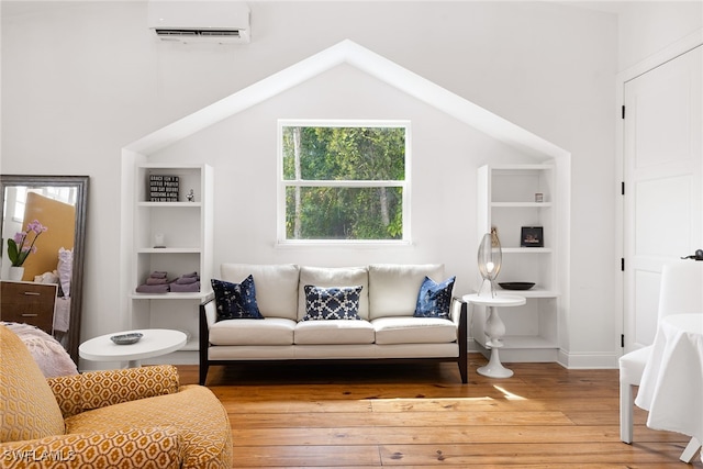 living room featuring hardwood / wood-style floors and an AC wall unit