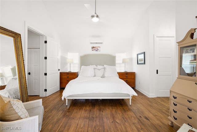 bedroom with ceiling fan, a closet, wood-type flooring, and an AC wall unit