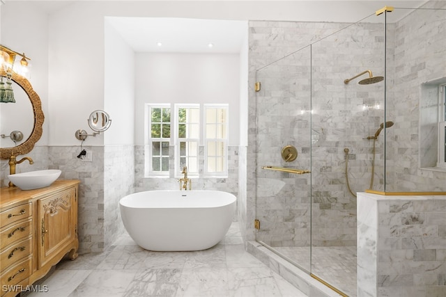 bathroom with vanity, tile walls, and independent shower and bath