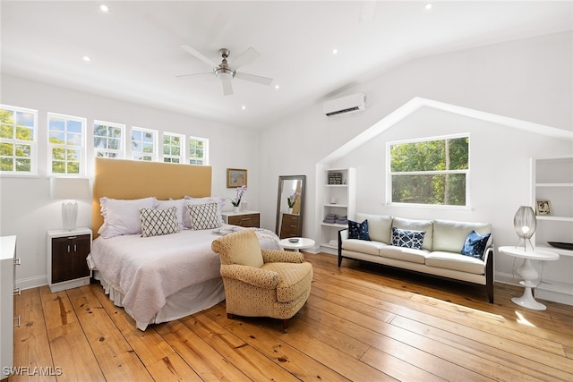 bedroom with light hardwood / wood-style floors, an AC wall unit, ceiling fan, and lofted ceiling