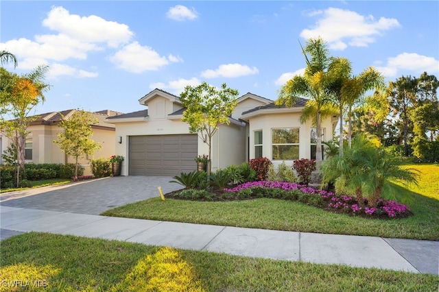 view of front facade with a garage and a front lawn