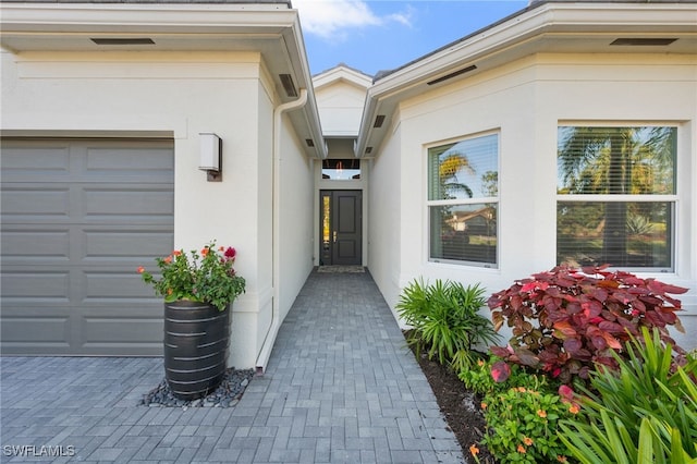 view of exterior entry featuring a garage