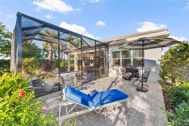 view of patio featuring a lanai and grilling area